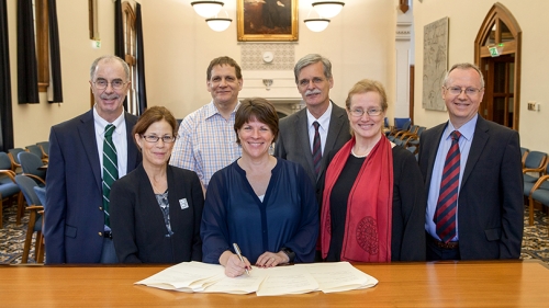 a group of people sitting behind a table